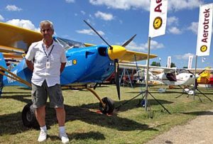 Aerotrek importer boss Rob Rollison stands in front of his EAA AirVenture Oshkosh 2016 display.